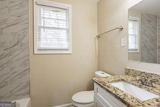 bathroom featuring toilet, baseboards, and vanity