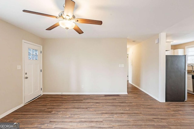 entrance foyer with dark wood-style floors, ceiling fan, and baseboards