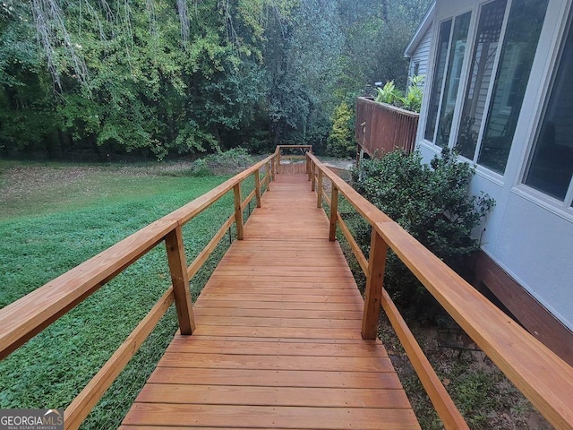 view of dock featuring a lawn