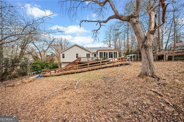 rear view of property featuring a wooden deck