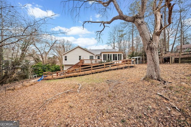 rear view of property featuring a deck