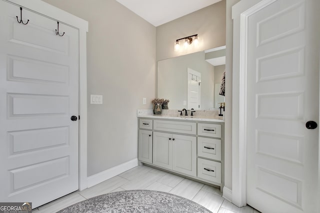 bathroom featuring baseboards and vanity