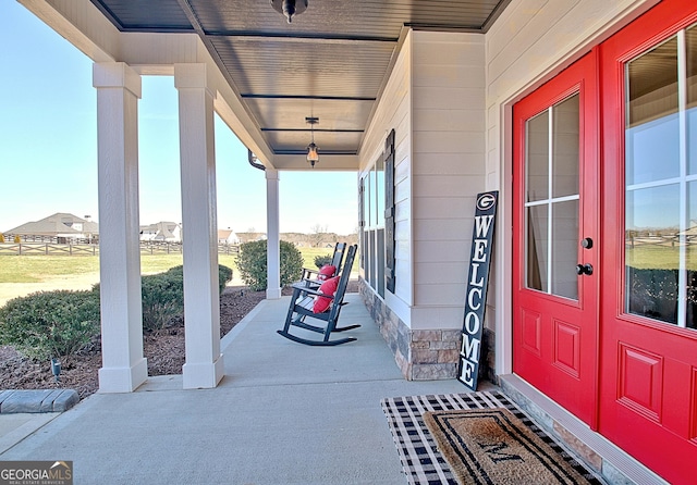 view of patio featuring a porch and french doors