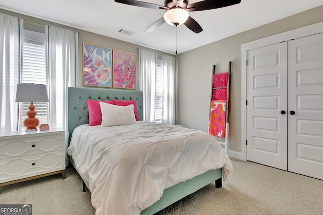 bedroom featuring carpet, a closet, visible vents, ceiling fan, and baseboards