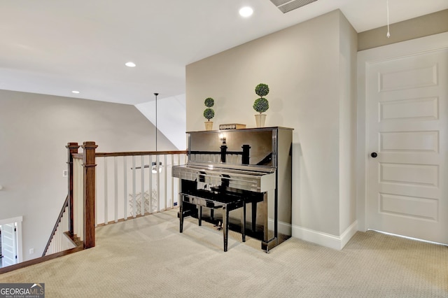 hall featuring recessed lighting, light colored carpet, and an upstairs landing