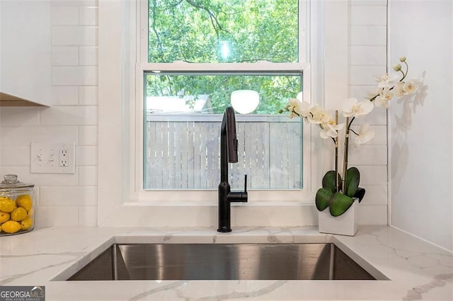 details with light stone counters and a sink