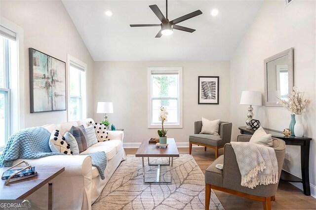 living area with light wood-style floors, lofted ceiling, and recessed lighting