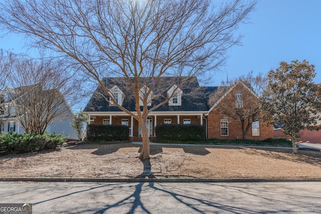 new england style home with brick siding