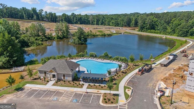 birds eye view of property with a water view and a forest view