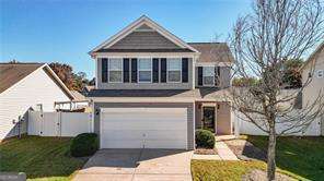 view of front of house with a garage, driveway, and a front yard