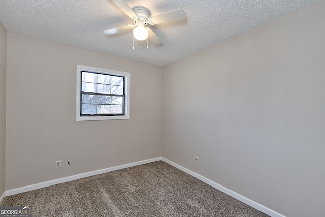 empty room with carpet flooring, ceiling fan, a textured ceiling, and baseboards