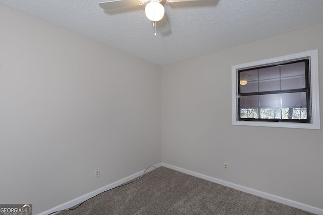 carpeted spare room featuring ceiling fan, baseboards, and a textured ceiling