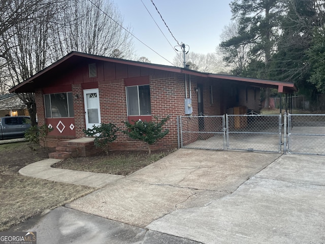 view of front of property featuring a gate, fence, and brick siding