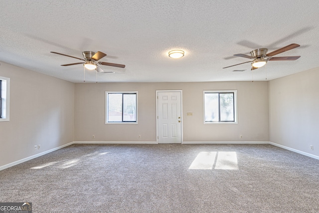 unfurnished room featuring carpet floors, plenty of natural light, baseboards, and ceiling fan