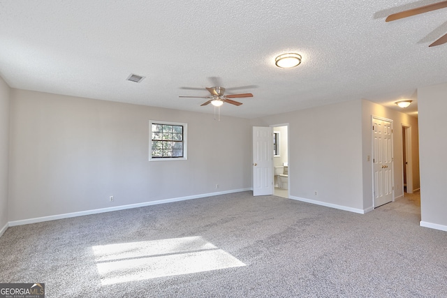 empty room with baseboards, light carpet, visible vents, and a ceiling fan