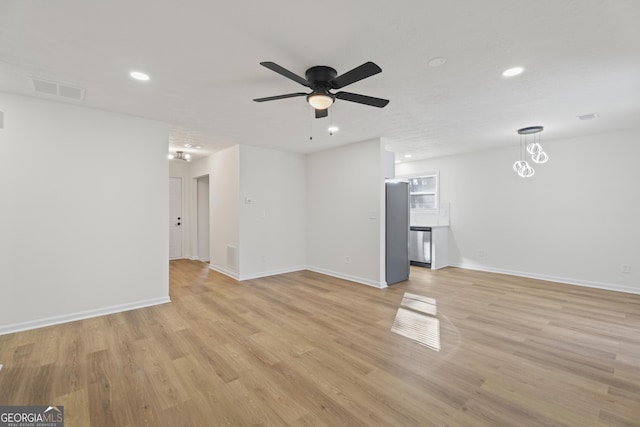 unfurnished living room with ceiling fan, light wood-style flooring, recessed lighting, visible vents, and baseboards