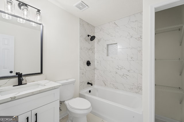 bathroom featuring toilet, visible vents, tub / shower combination, and vanity