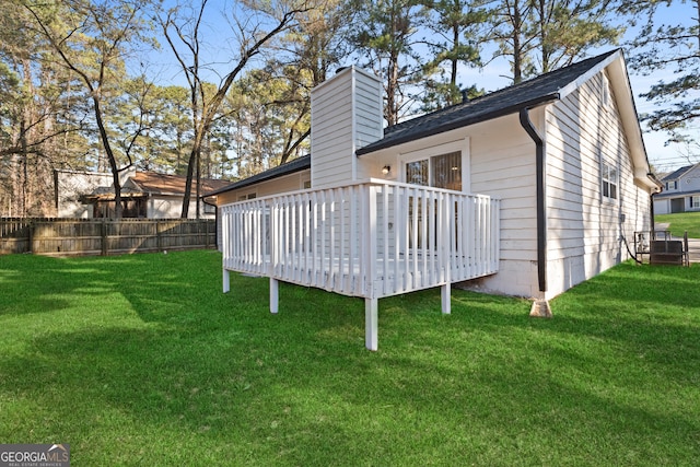 view of yard with fence and a deck