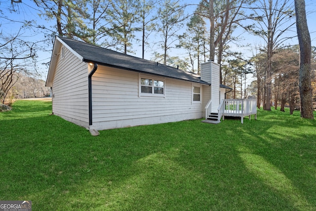 view of home's exterior featuring a chimney, a deck, and a lawn