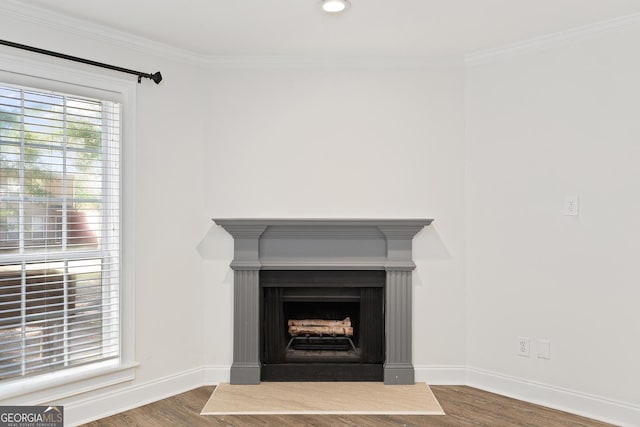 interior details with recessed lighting, a fireplace, wood finished floors, baseboards, and crown molding