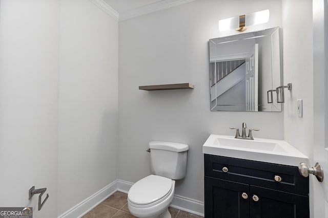 bathroom featuring crown molding, toilet, vanity, tile patterned flooring, and baseboards