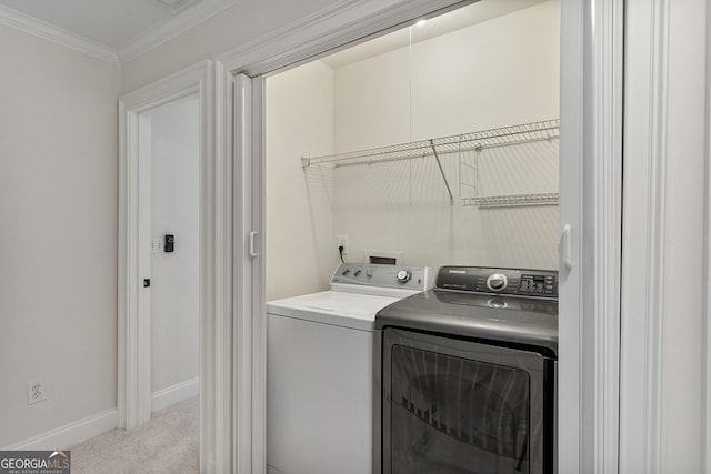 laundry room with laundry area, baseboards, light colored carpet, ornamental molding, and separate washer and dryer