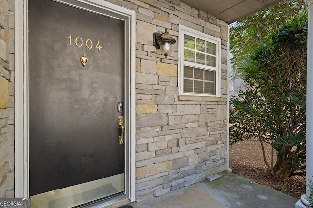 entrance to property with stone siding