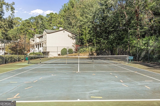 view of sport court featuring fence