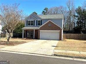 traditional-style home featuring a garage and driveway