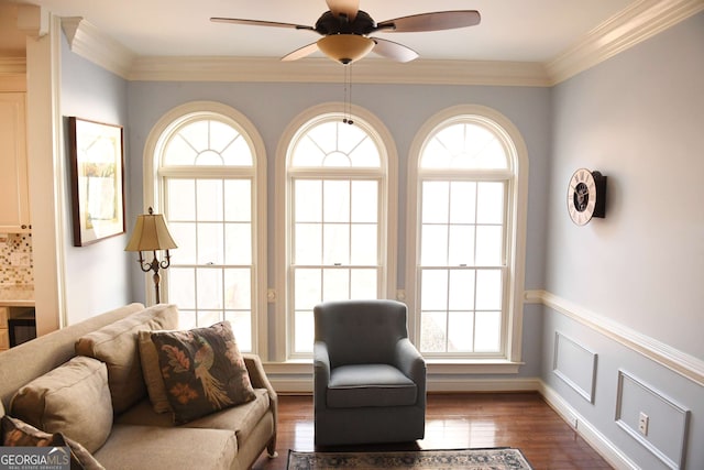 living room featuring plenty of natural light and crown molding