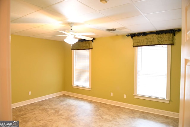 empty room featuring plenty of natural light and baseboards