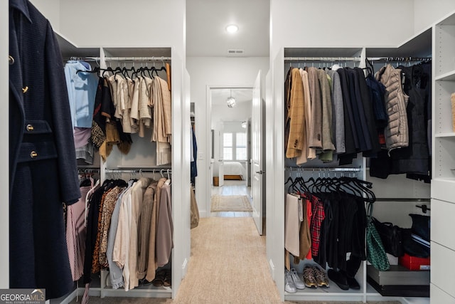 walk in closet with carpet and visible vents