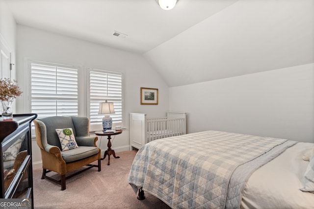 bedroom with light carpet, baseboards, visible vents, and lofted ceiling