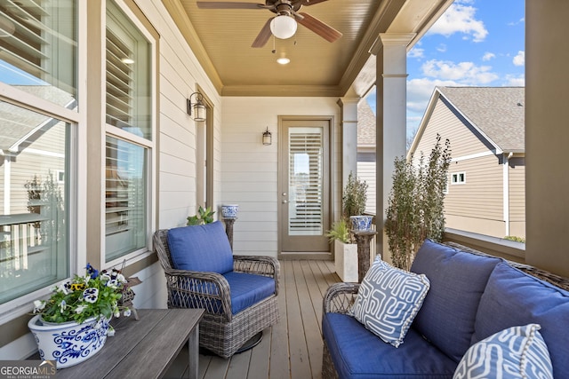 deck with covered porch and a ceiling fan