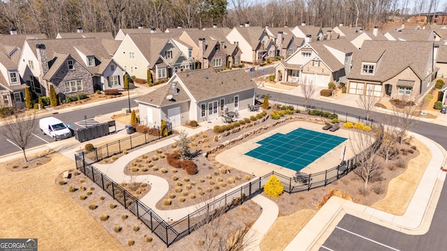 view of swimming pool featuring a patio area, a residential view, fence, and a fenced in pool