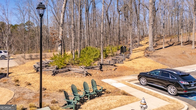 view of yard featuring a forest view