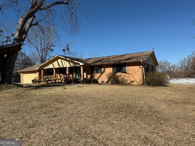 back of house with crawl space and a lawn