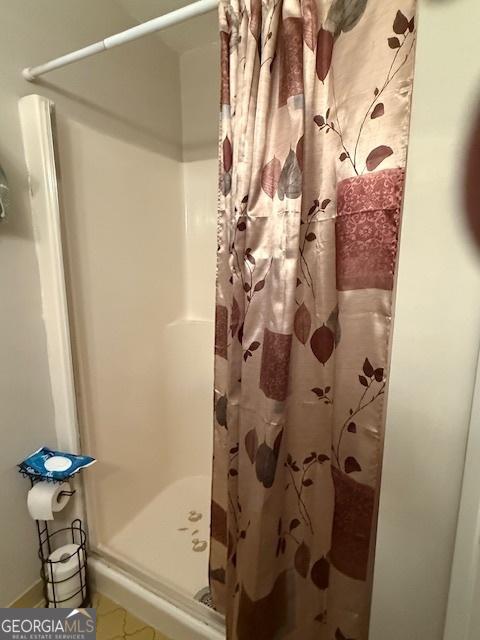 bathroom with a shower stall