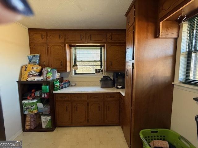 kitchen with brown cabinets, light floors, and light countertops