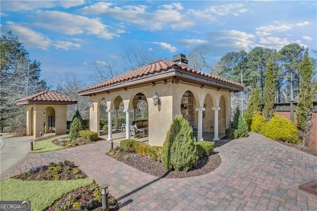 view of home's community with a patio area, fence, and a gazebo