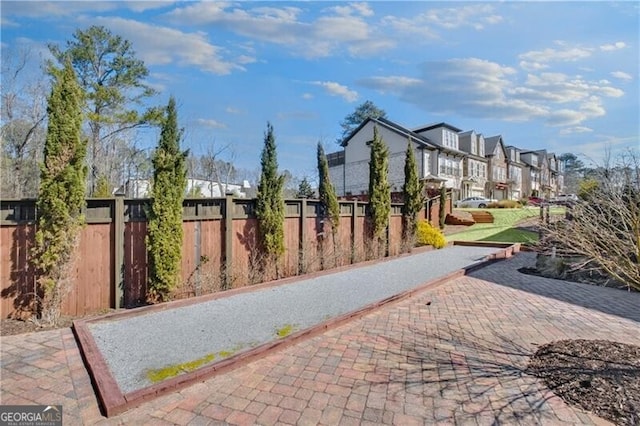 view of community featuring fence and a residential view