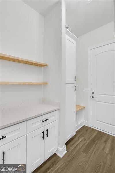 interior space with baseboards and dark wood-style flooring