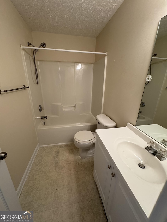 full bath featuring toilet, washtub / shower combination, a textured ceiling, vanity, and tile patterned floors