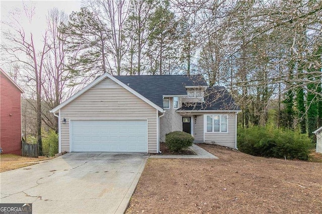 traditional home featuring a garage and concrete driveway