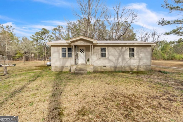 view of front of house featuring metal roof, a front lawn, and crawl space