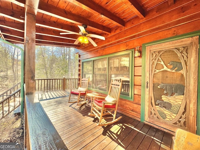 wooden deck featuring a ceiling fan