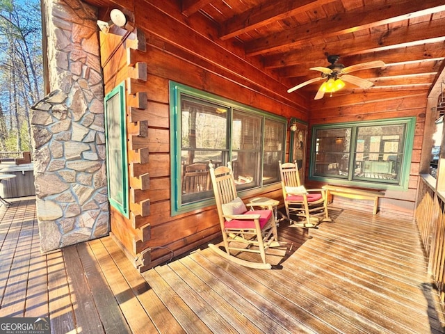 wooden deck featuring a ceiling fan