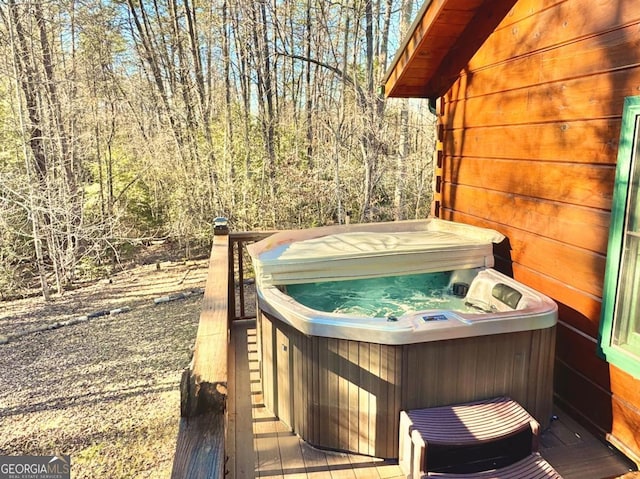 deck featuring a hot tub