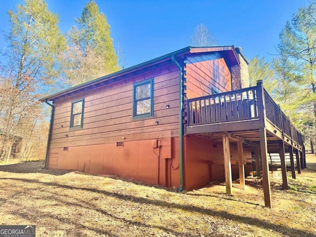 view of side of home featuring crawl space and a deck