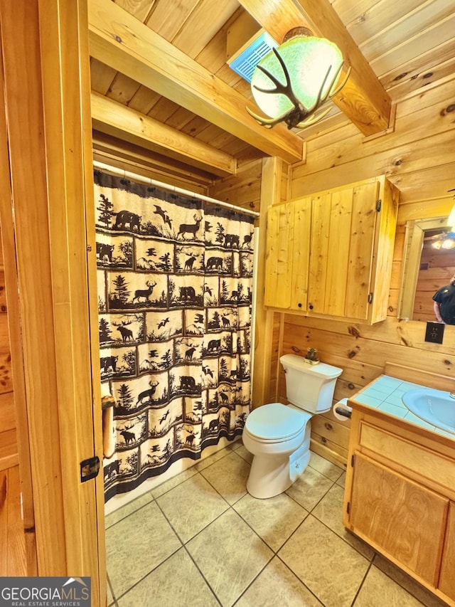 bathroom featuring wood ceiling, wood walls, tile patterned flooring, and beam ceiling